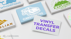 A collection of transfer decals in stacks on a table.
